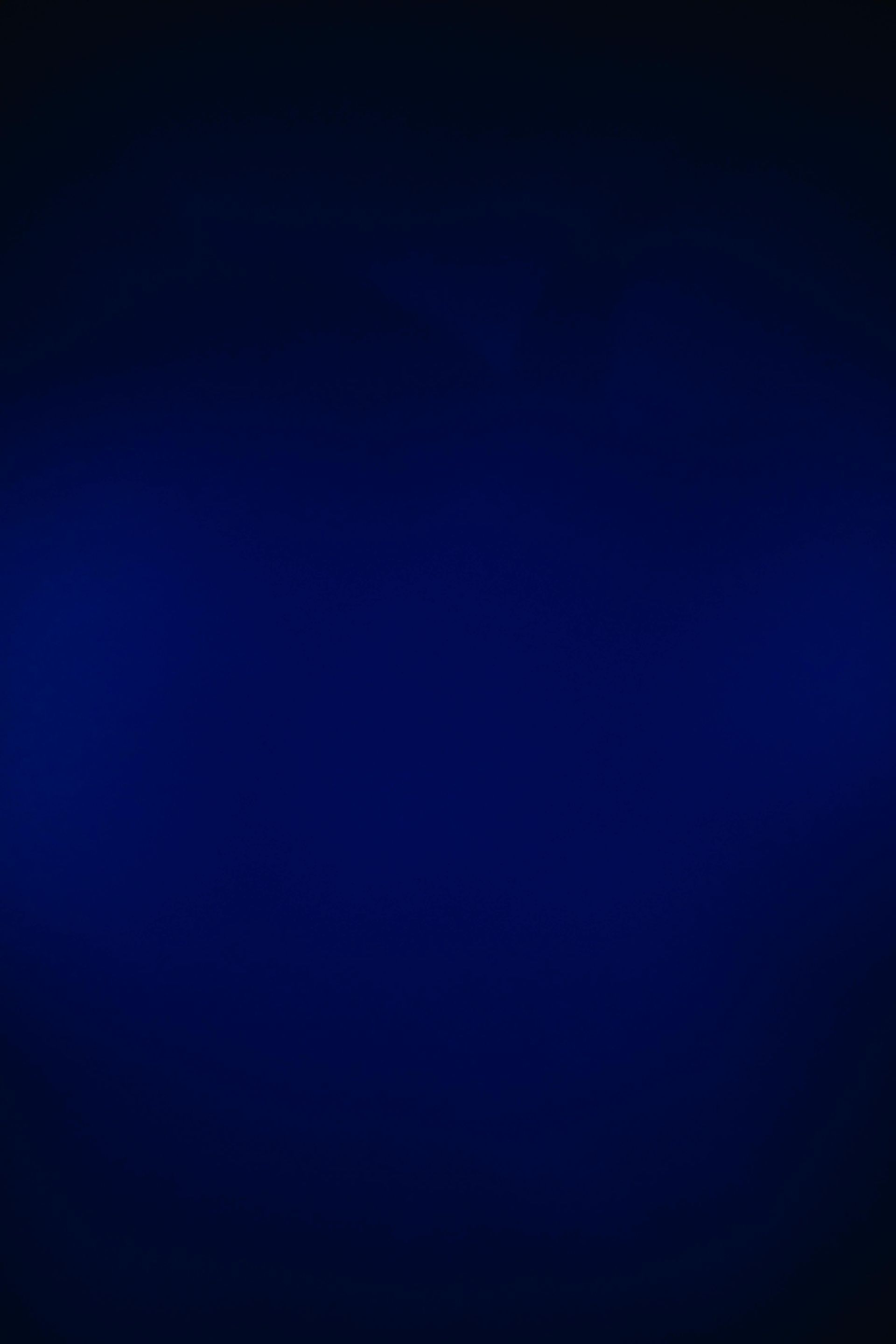 Dark blue gradient background with a subtle glow in the center